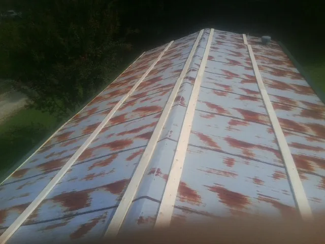 Rusted metal roof panels with new wood purlins before replacement — Storm Damage Roof Repair in Big Indian by Roofing Brothers