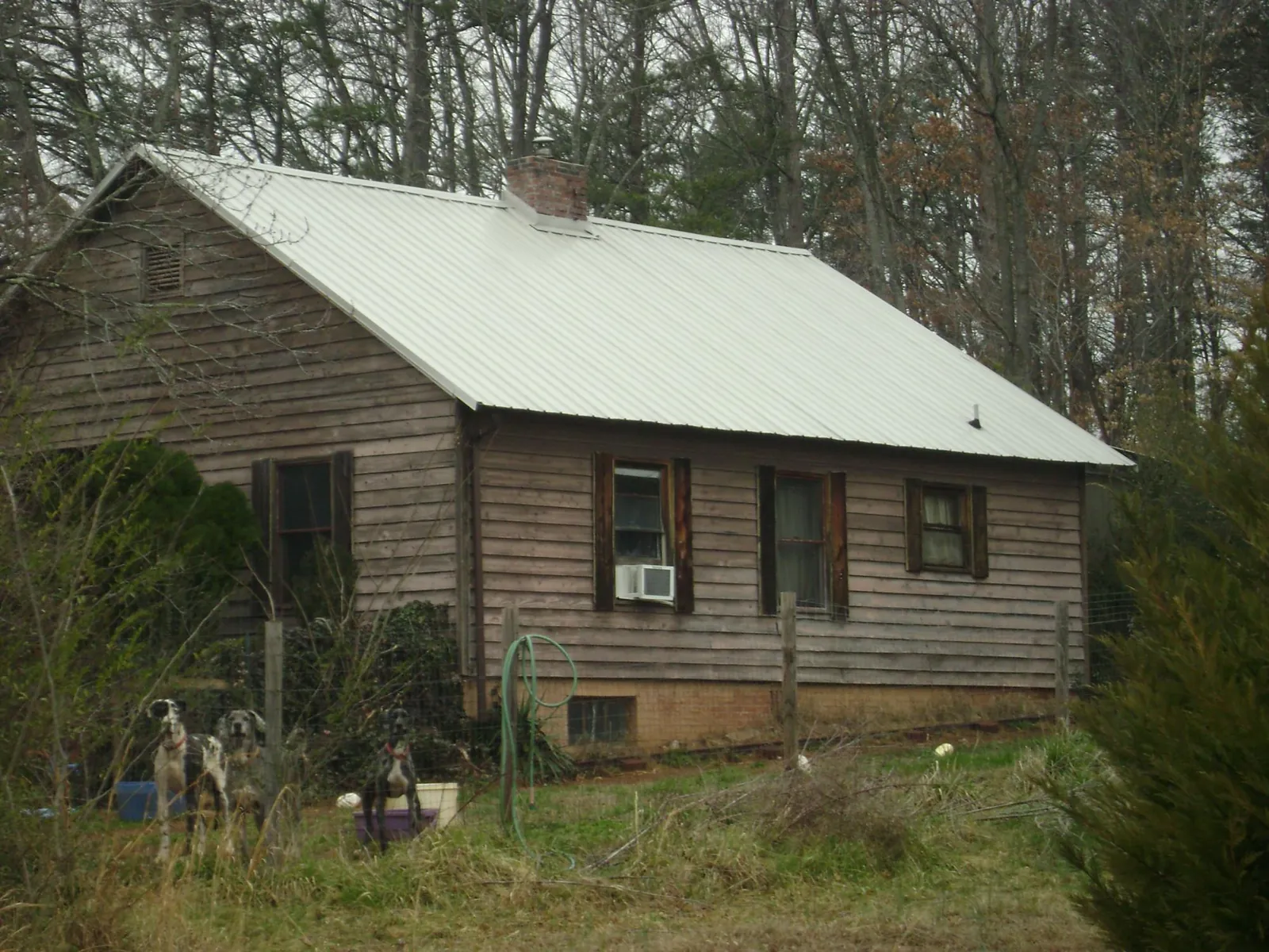 White metal roof on an old wood sided farmhouse, from a Metal Roof Installation job in Big Indian